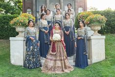 a group of women standing next to each other in front of a building