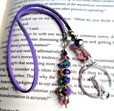 a book with a purple necklace on top of it