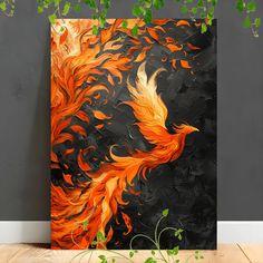 an orange and black painting on a wall next to a plant in a room with grey walls