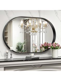 a large mirror sitting on top of a mantle next to a vase filled with flowers