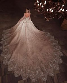 a woman in a wedding dress is standing on the floor with her back to the camera