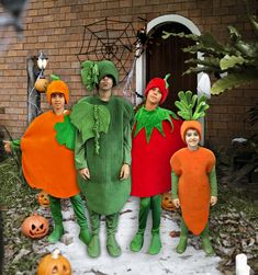 three people dressed in costumes standing next to each other with carrots on their heads