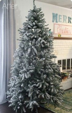 a white christmas tree sitting in front of a window