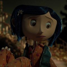 an animated character with blue hair holding something in her hand and looking at the camera