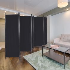 a room divider in the middle of a living room with a couch and coffee table