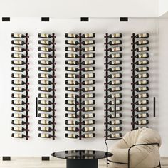 a wine rack is mounted on the wall next to a chair and table in front of it