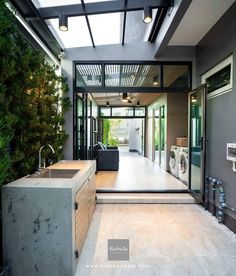 an open concept kitchen and living room with skylights