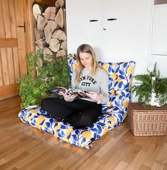 a woman sitting in a chair with a tablet