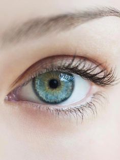 a woman's blue eye with long lashes