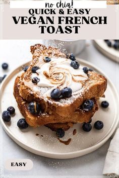 two pieces of french toast on a plate with blueberries and powdered sugar