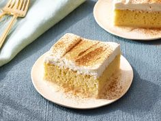 two plates with slices of cake on them next to a fork and napkin, along with a blue towel