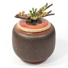 a brown vase with some branches in it