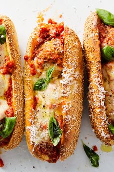 three sandwiches with meat, cheese and spinach