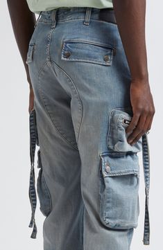 When it comes to combining beloved denim with the cargo comeback, Amiri completes the mission with pocket-popped jeans cut with plenty of stretch. 33 1/2" inseam; 15" leg opening; 11" front rise; 14" back rise (size 32) Button fly Front patch pockets; cargo snap-flap pockets; cargo zip pocket Drawstring hems 92% cotton, 6% elastomultiester, 2% elastane Dry clean Made in the USA Designer Clothing Urban Cargo Jeans With Belt Loops In Rigid Denim, Distressed Straight Leg Utility Cargo Jeans, Utility Style Distressed Straight Leg Cargo Jeans, Streetwear Rigid Denim Cargo Jeans With Belt Loops, Urban Dark Wash Cargo Jeans With Belt Loops, Rigid Denim Cargo Jeans With Belt Loops For Streetwear, Urban Cargo Jeans With Belt Loops In Medium Wash, Distressed Utility Cargo Jeans In Medium Wash, Distressed Medium Wash Utility Cargo Jeans