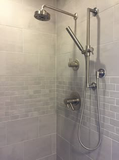 the shower head and handset are connected to the faucet in this bathroom