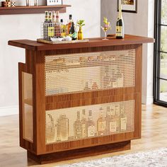 a wooden bar with bottles on top of it in front of a window and rug