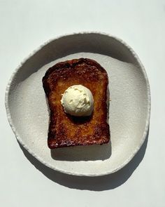 a piece of toast with ice cream on top