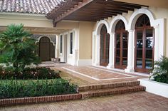 an outside view of a building with plants and flowers