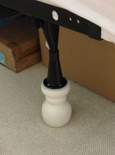 a black and white object sitting on top of a bed