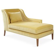 an upholstered chaise lounge chair with pillows