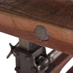 a close up of a wooden bench with a metal object on the top and bottom