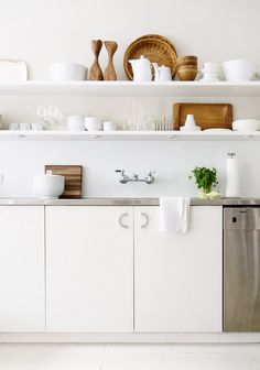 the kitchen is clean and ready to be used for cooking or serving dishes on the shelves