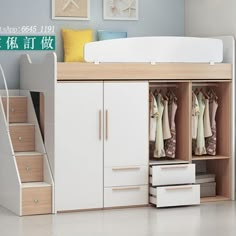 a white bunk bed sitting next to a wooden dresser and stairs in a room with pictures on the wall