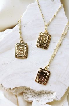 our *pre-order* square pendant initial necklaces are the go-to essential for any look you're pulling these days // each monogram pendant features a design in dimensional relief that has been polished to perfection to sparkle against your skin the pendant measures approximately 1” and comes on an 18” chain with an added extender chain gold plated: this necklace is tarnish resistant, the gold plating receives an additional protective coat that allows for frequent wearing without the worry of your Letter Necklace Initials, Square Pendant Necklace, Gold Pendent, Dainty Initial Necklace, Mobile Boutique, Monogram Pendant, Letter Pendant Necklace, Initial Necklace Gold, Gold Monogram