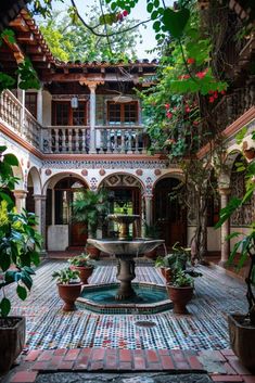 a courtyard with a fountain surrounded by potted plants