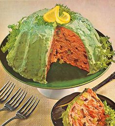 the cake is covered in lettuce and has a slice taken out of it