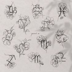 the letters and numbers are drawn with black ink on a sheet of paper that has flowers in it