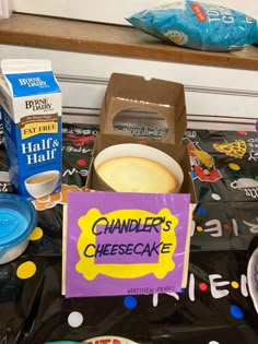 a table topped with lots of food next to boxes of milk and other items on top of it