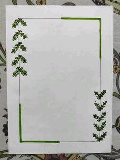 a piece of paper that has been drawn with green lines on it and some leaves in the corner