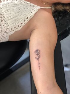 It’s a small tattoo on the inner arm with the name of a loved one embedded in the rose Rose Tattoo With Initials, Tattoo Flower Name, Inner Arm Flower Tattoo, Rose With Name Tattoo, Tattoos Inner Arm, Rose Linework, Flower Name Tattoo, Name Flower Tattoo, Rose Tattoo With Name