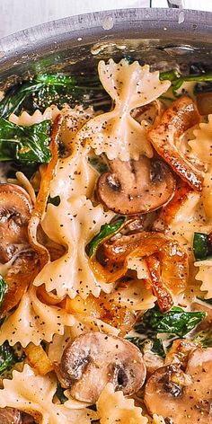 pasta with mushrooms, spinach and cheese in a pan