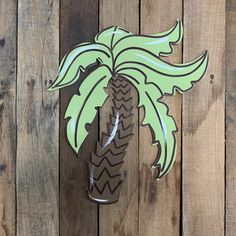 a wooden fence with a palm tree cut out of it's side on the wall