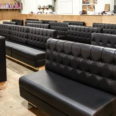 rows of black leather seats in a room