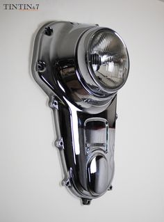 a close up of a headlight on a white wall