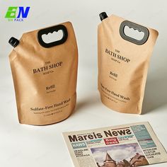 two brown paper bags sitting next to each other on top of a white countertop