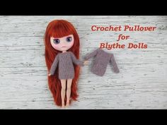 a doll with long red hair holding onto a gray knitted mitt that says crochet pullover for blythe dolls is on your tube now