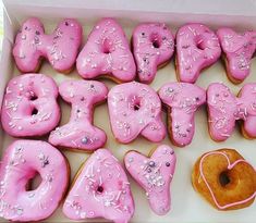 a box filled with pink donuts covered in frosting