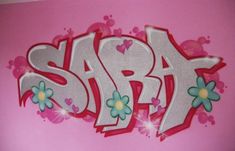 the word spa is painted in white and pink with flowers on it's side