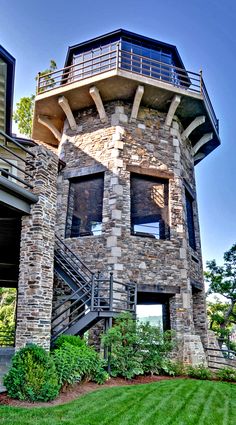 a very tall brick building with stairs leading up to it's second floor and windows