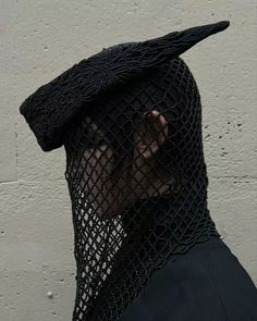 a man wearing a black netted hat