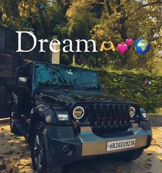 a black jeep parked in front of a building with the words dream on it's side