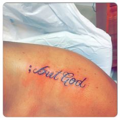 a person with a tattoo that says, but god