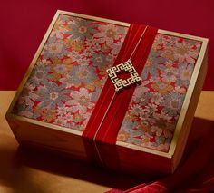 an open box with a red ribbon around it