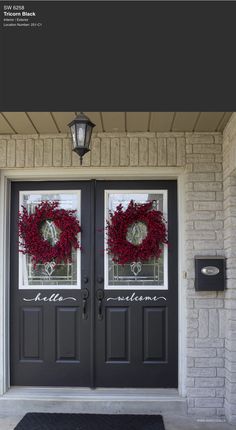 two double doors with wreaths on them and the words hello welcome written in white