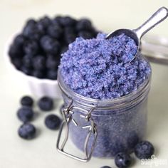 blueberries in a jar with a spoon next to it