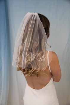 a woman wearing a veil with the word miss written on it